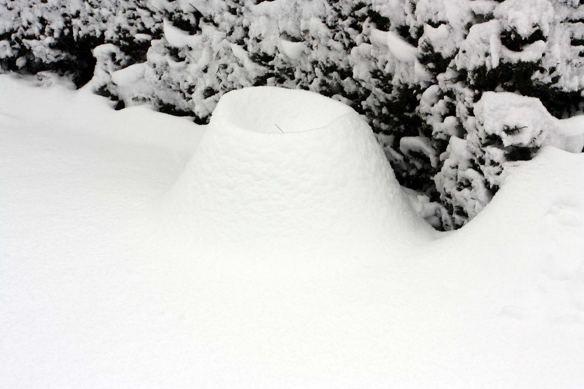 Een aardewerk pot is compleet ondergesneeuwd.
